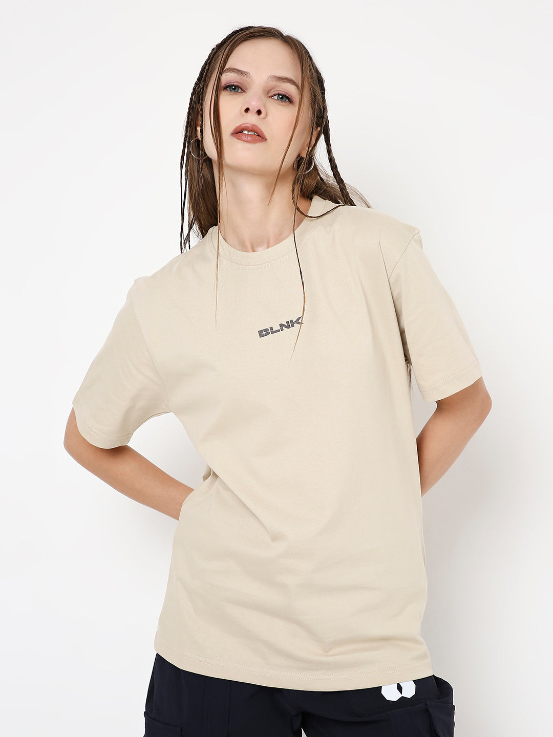 Beige relaxed fit T-shirt with small black text logo on chest, short sleeves, crew neck.