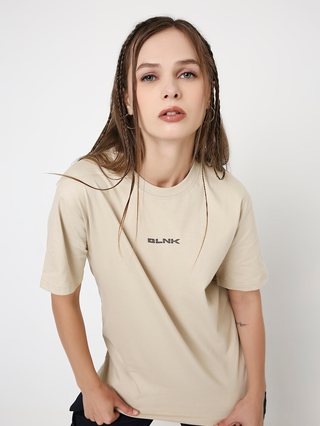 Beige relaxed fit t-shirt with small black "SILNCE" text on chest, short sleeves.