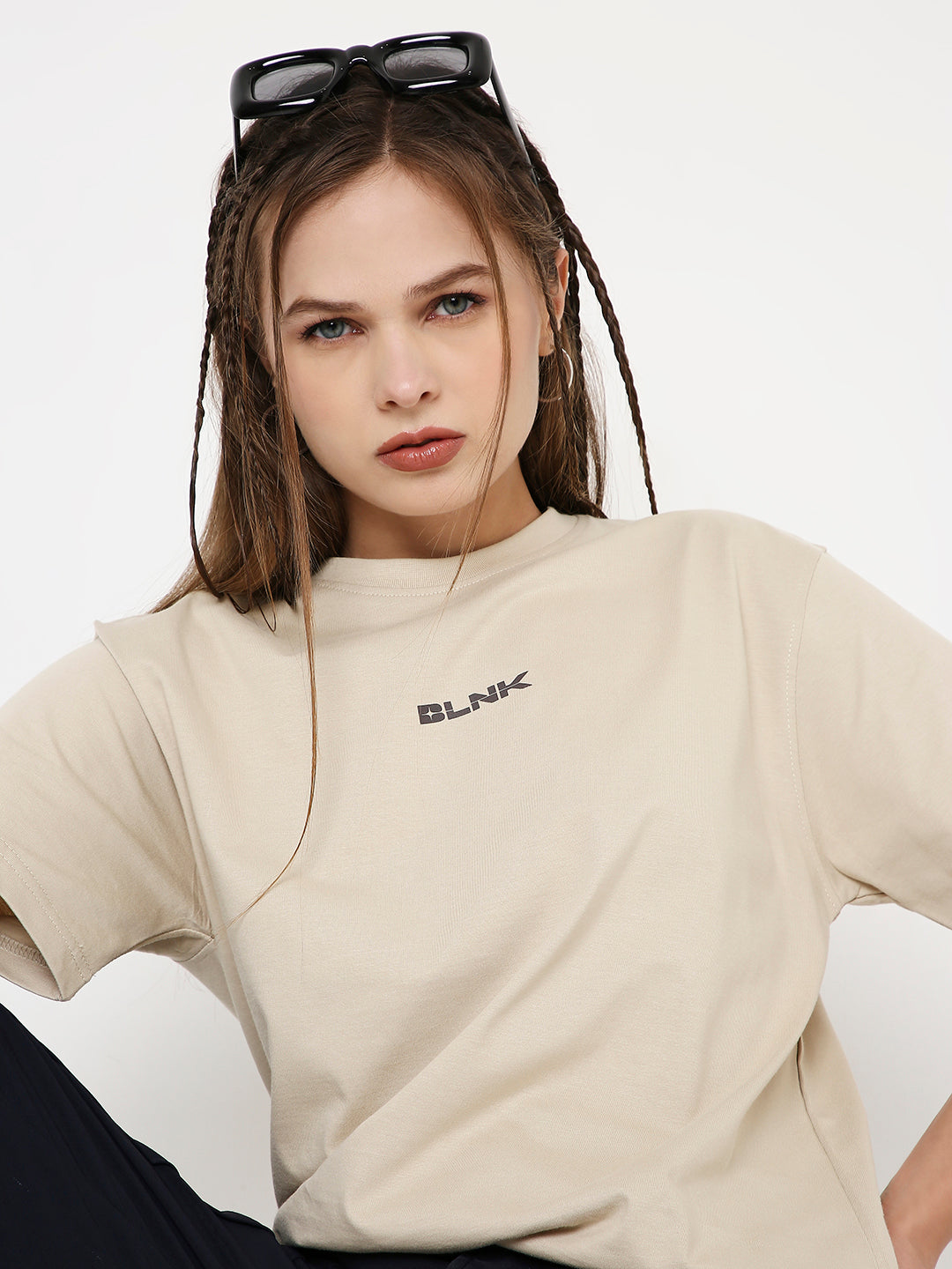 Beige relaxed fit t-shirt with small black "BLANK" logo on chest and crew neckline.