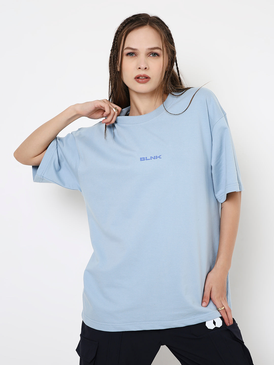 Light blue oversized t-shirt with small centered text print, worn with black shorts.