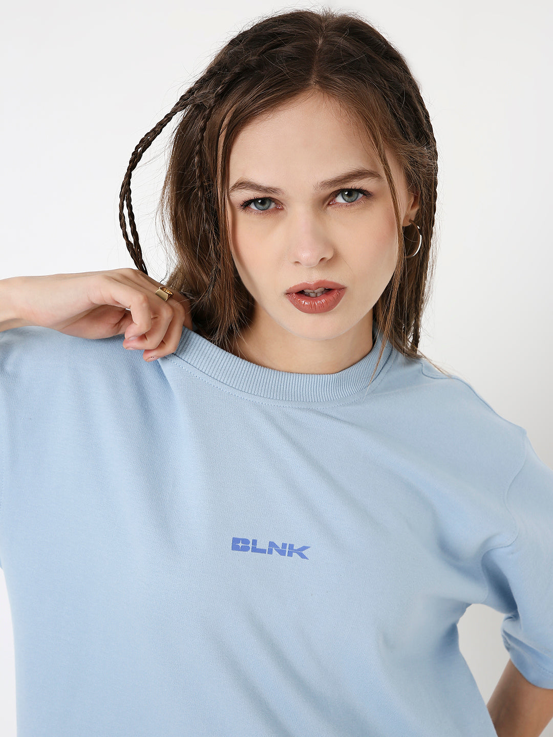 Light-blue oversized t-shirt with small centered blue "BLVK" print on chest.