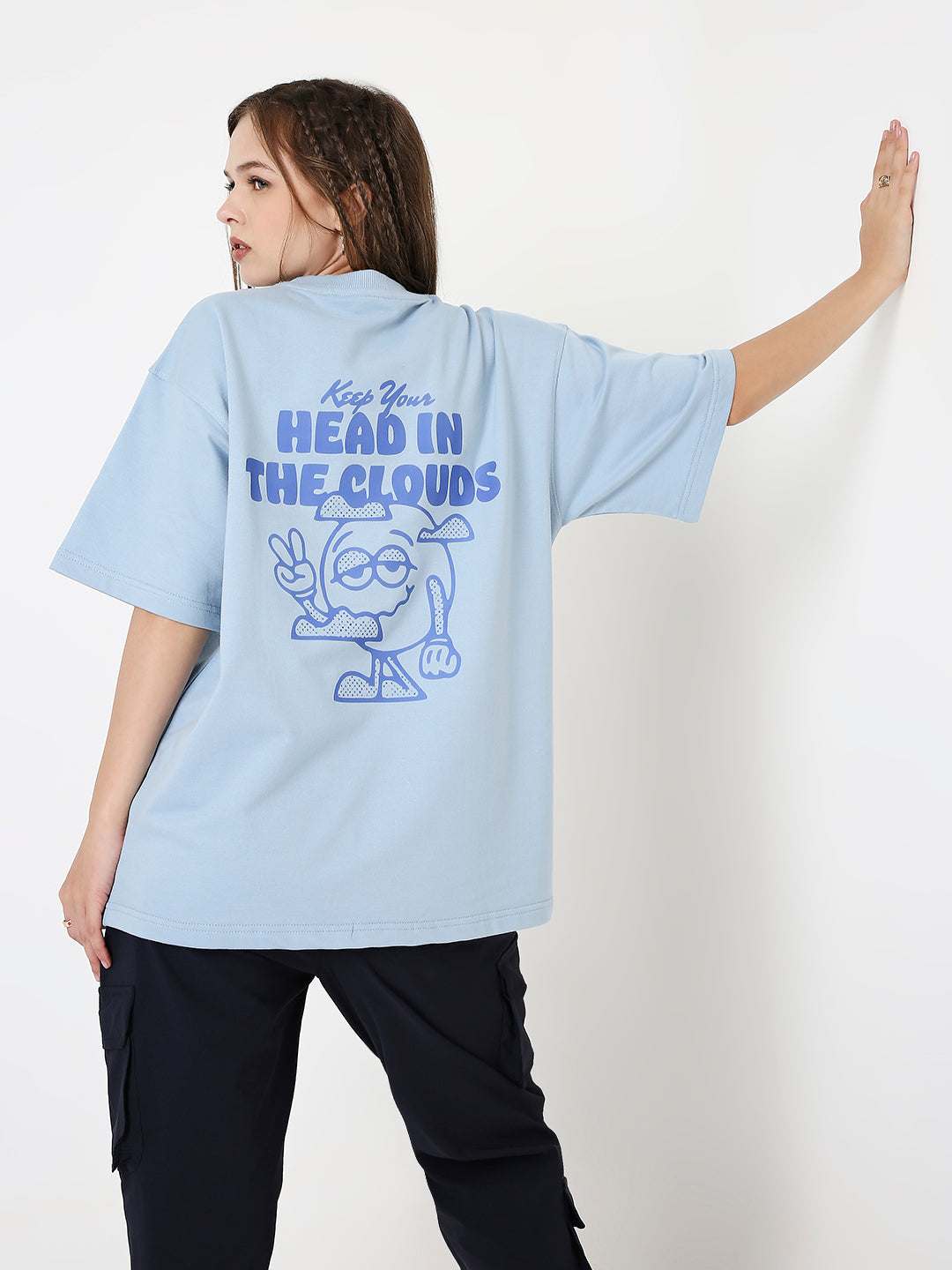 Oversized light-blue t-shirt with blue cartoon and "Head in the Clouds" text on back.