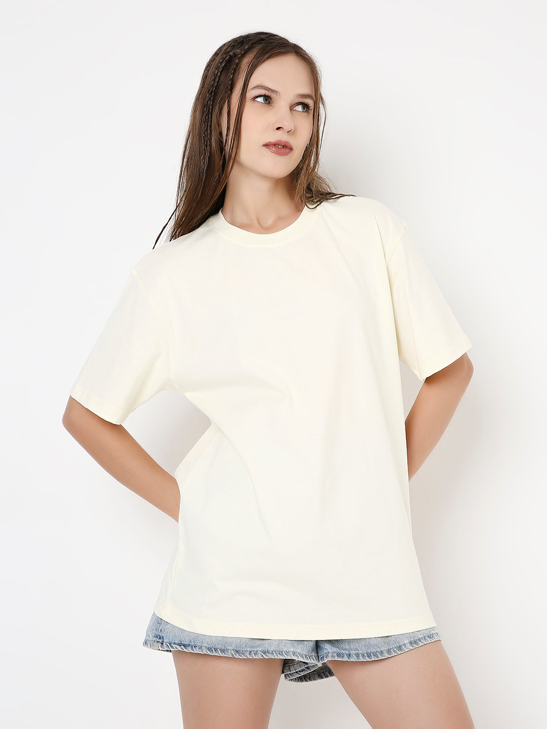 Off-white relaxed fit short sleeve t-shirt with round neckline worn with denim shorts.