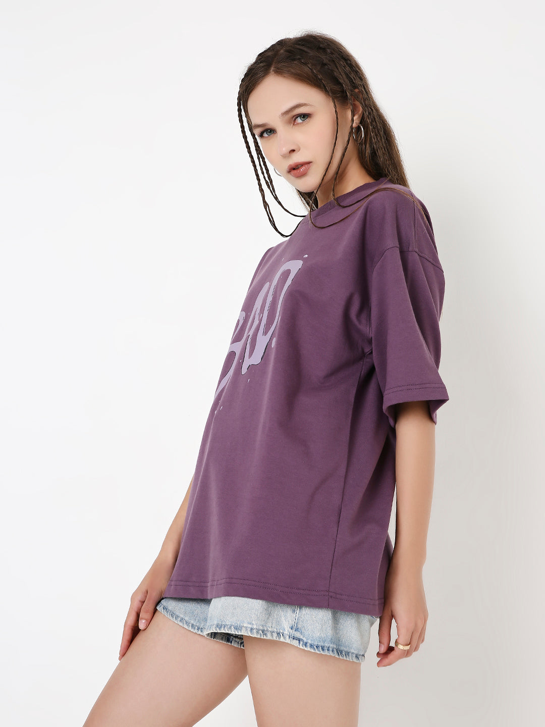 Purple oversized t-shirt with large white grape graphic, paired with light denim shorts.