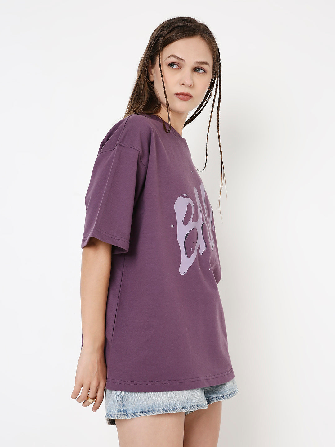 Oversized purple t-shirt with large white grape print, styled with denim shorts.