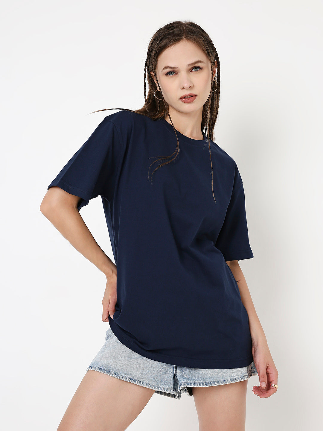 Navy-blue relaxed fit T-shirt with short sleeves, paired with light denim shorts.