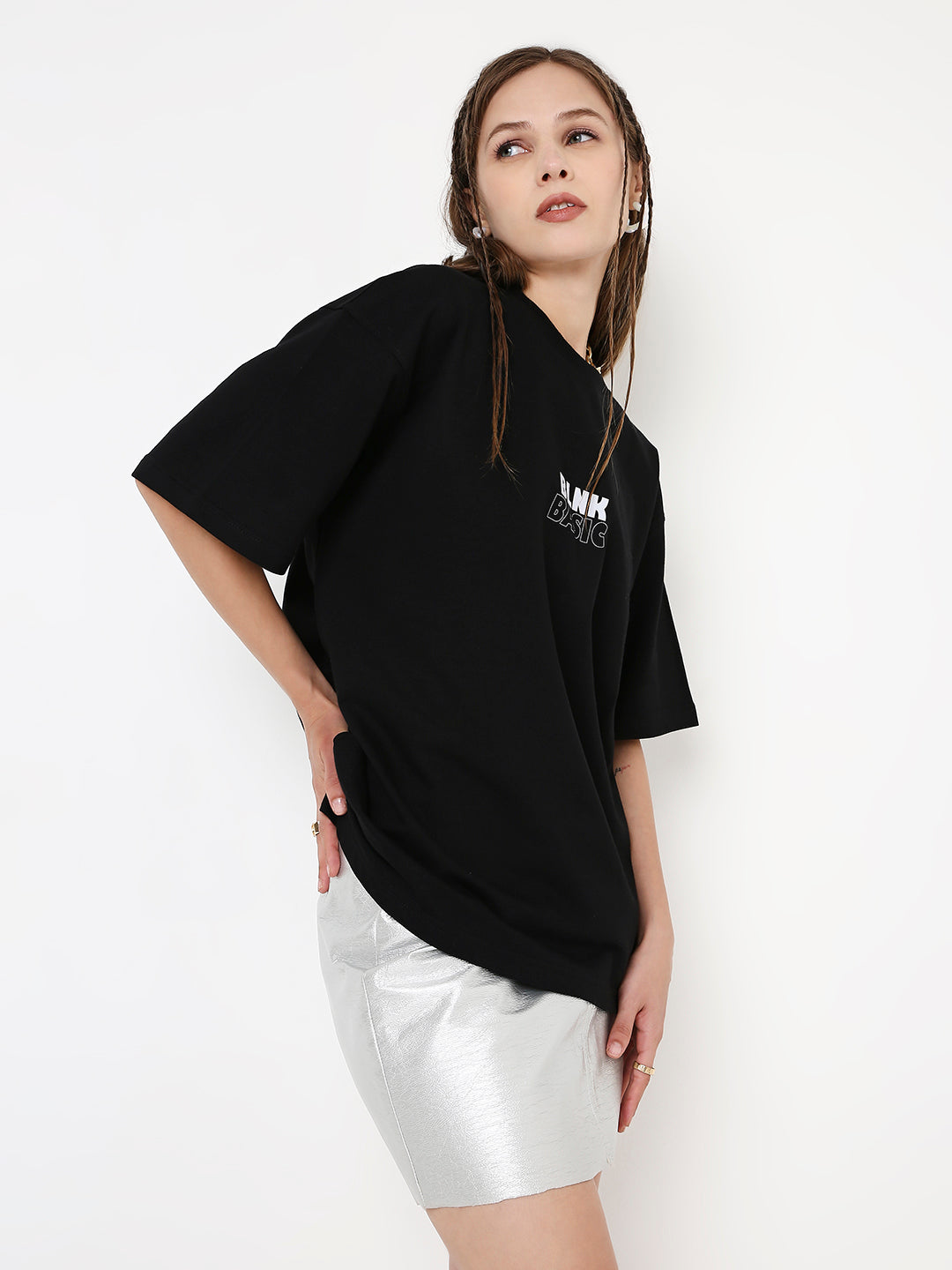 Oversize black T-shirt with white printed text, worn with white shorts.