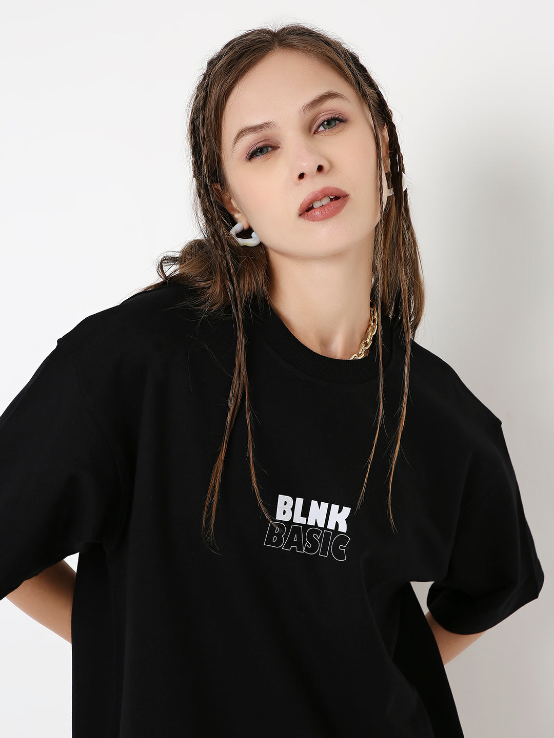 Oversize black t-shirt with white BLNK BASICS print and short sleeves on a model.