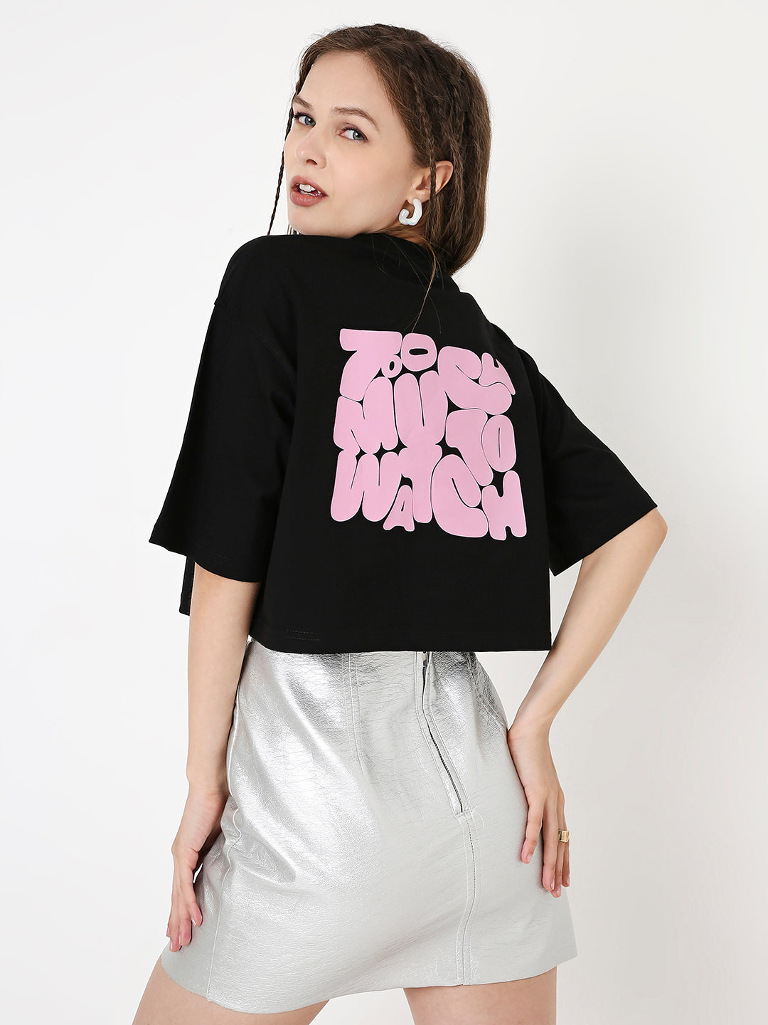 Oversize black crop top with bubblegum pink graphic print on back, paired with silver metallic skirt.
