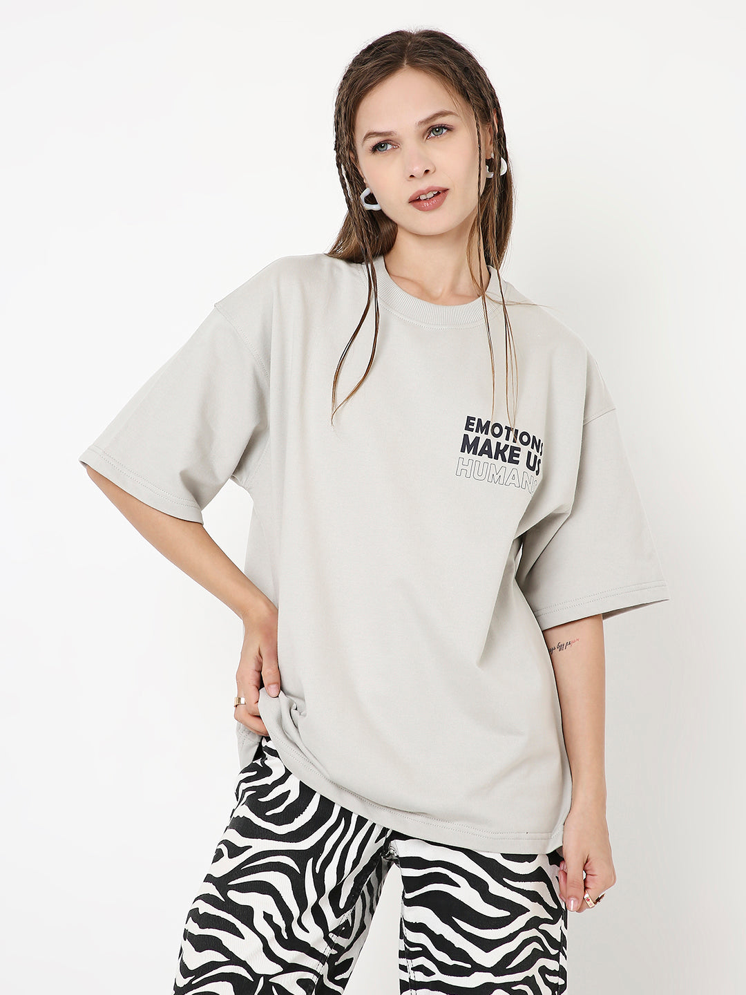 Oversize light gray t-shirt with black text on left chest and loose short sleeves.