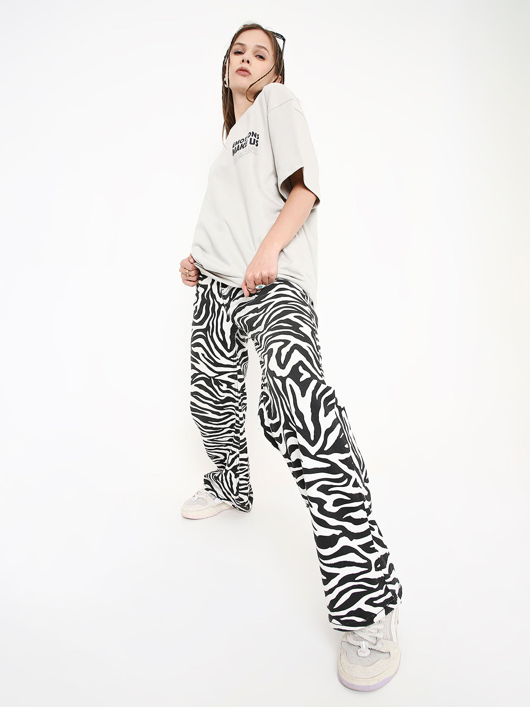 Oversize white t-shirt with black stone print paired with black and white zebra print wide-leg pants.