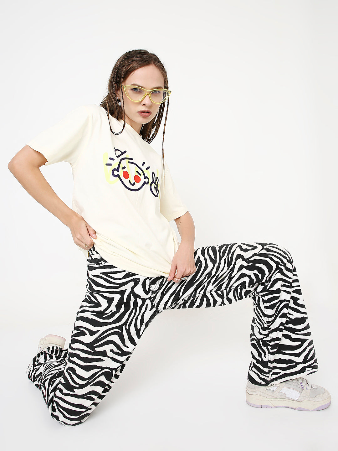 Off-white relaxed fit t-shirt with colorful cartoon face print on front.