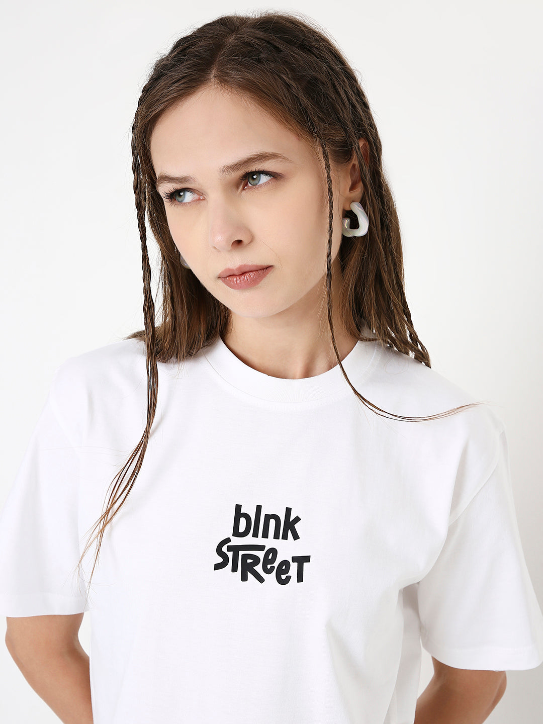 White relaxed fit T-shirt with black "blnk Street" text printed on front, crew neckline.