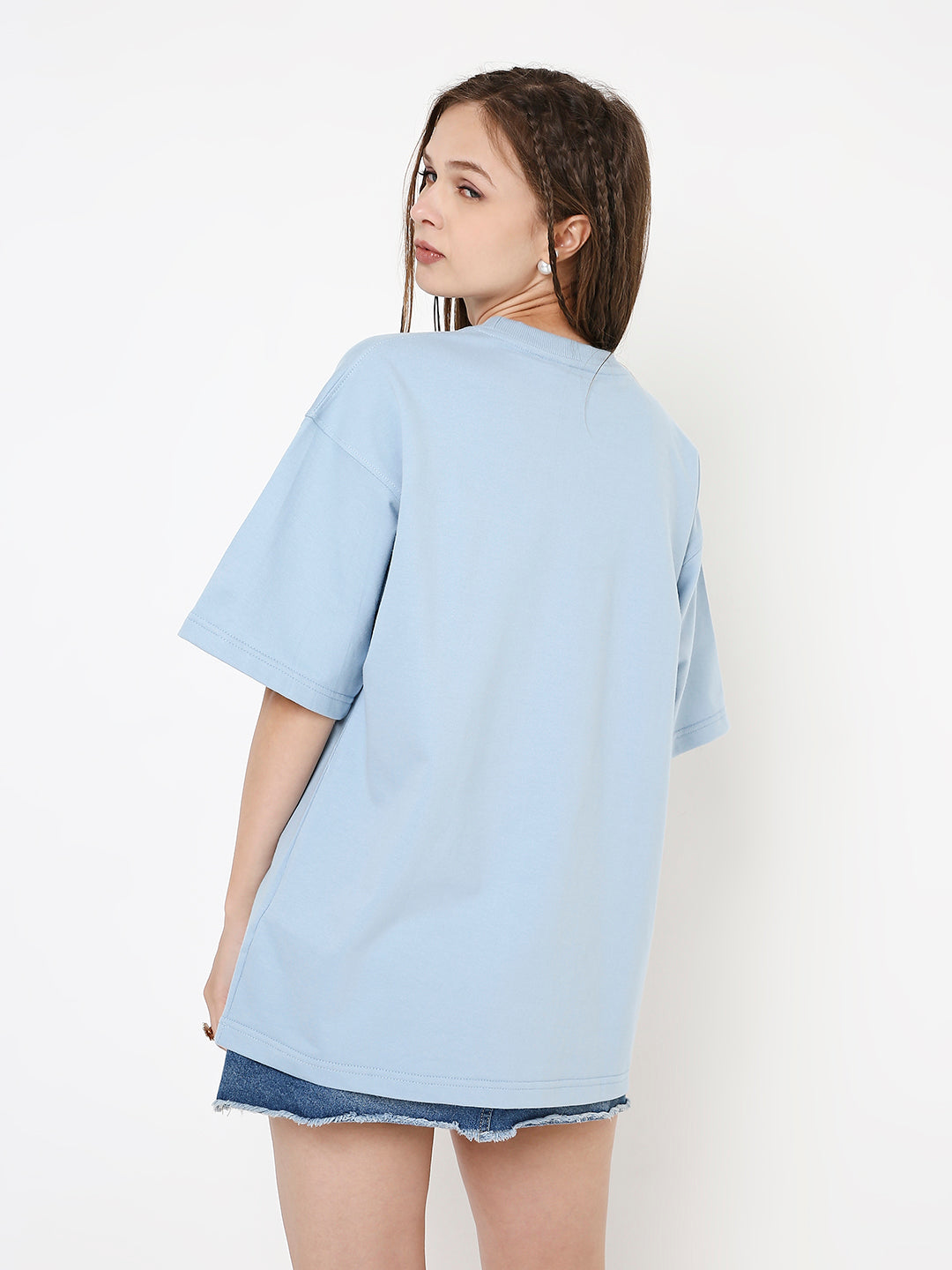 Oversize light blue solid t-shirt with short sleeves, worn loose over denim shorts.