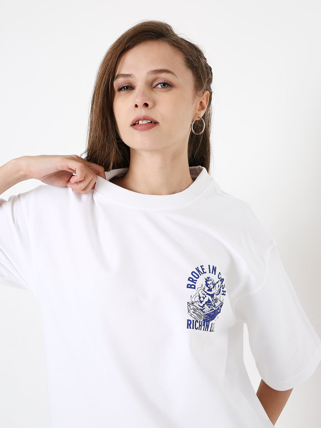 Oversize white t-shirt with blue circular graphic and text on chest, short sleeves.