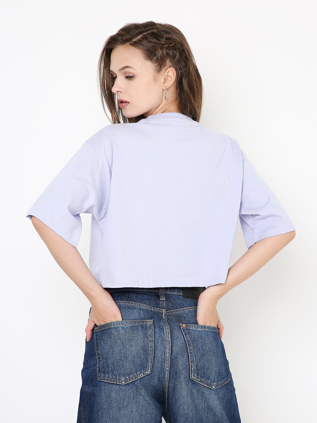 Lavender oversized crop top with short sleeves and a boxy fit, worn with high-waisted jeans.