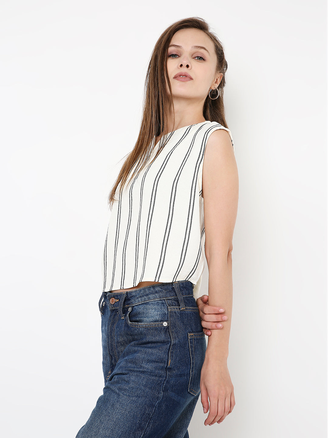 White sleeveless crop top with vertical black stripes and round neckline.