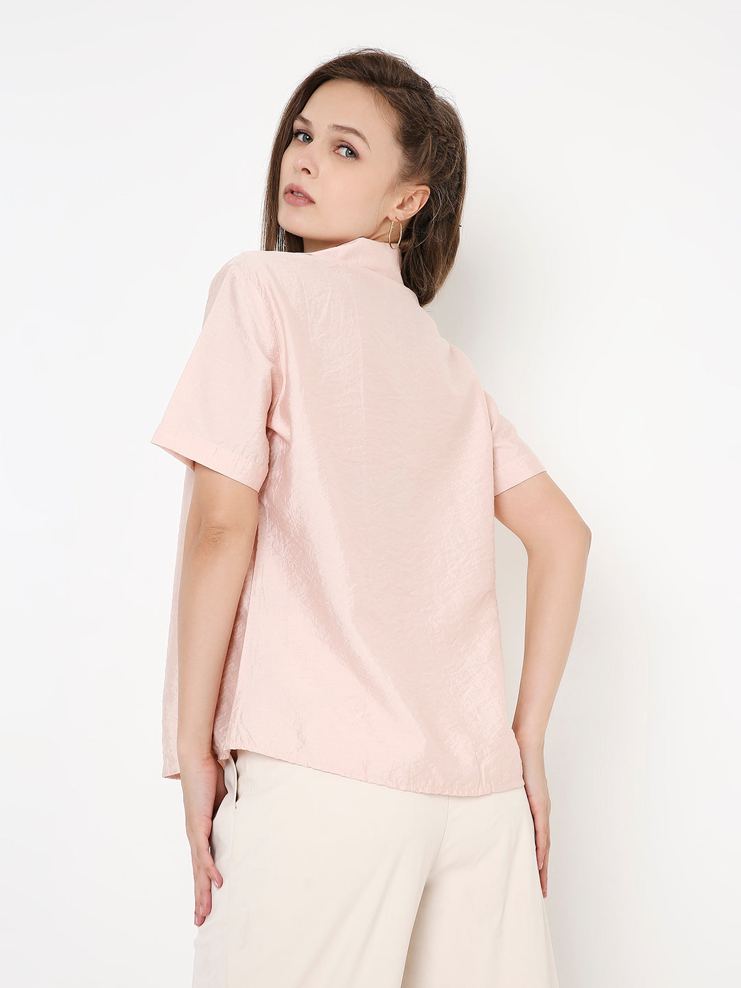 Light peach short-sleeve shirt with a relaxed fit, featuring a simple back design and soft, smooth fabric.