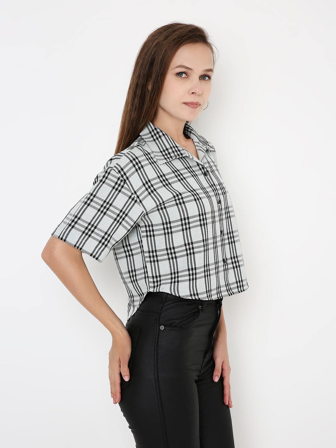 Black and mint green checked short-sleeve crop shirt with collar, worn tucked into black high-waisted pants.