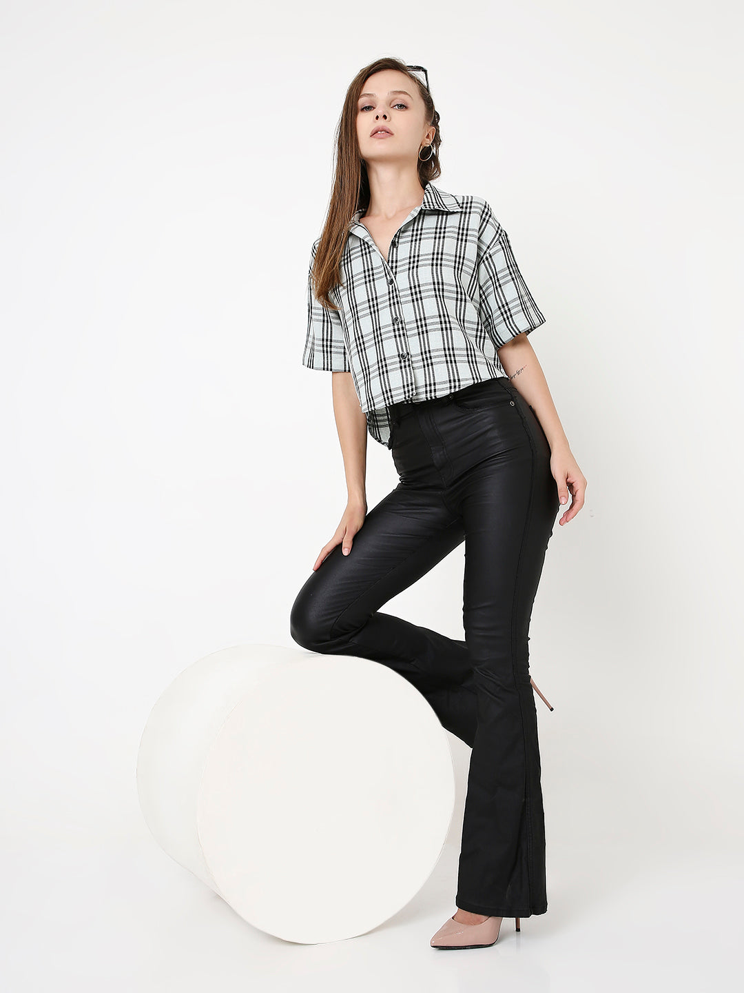 Black and mint green checked short-sleeve crop shirt with collar, styled with black flared pants and heels.