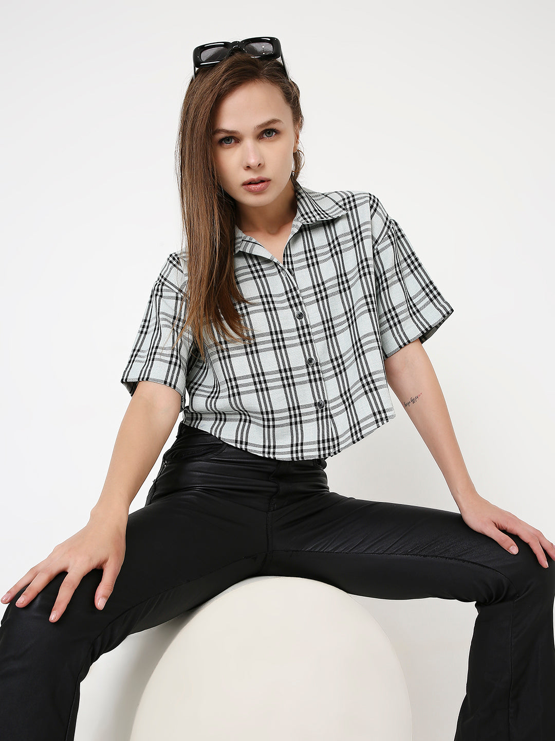 Black and mint green checked crop shirt with short sleeves and collar, paired with black pants.