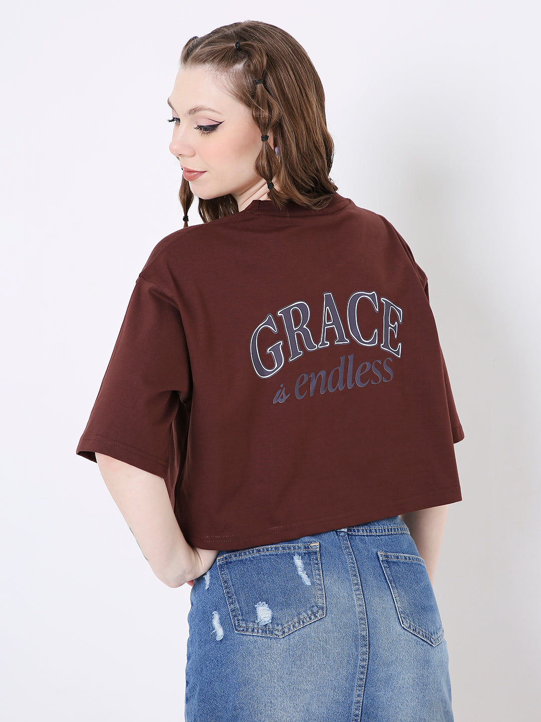 Oversize brown crop top with blue "Grace is endless" print on back and short sleeves.