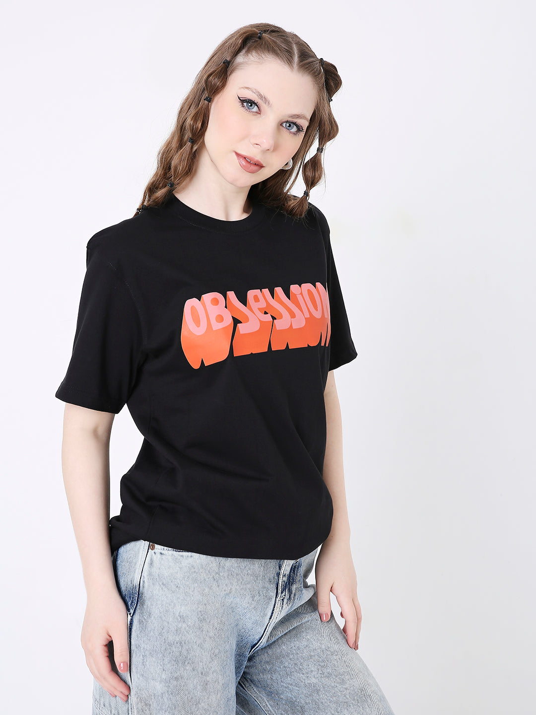 Black relaxed fit t-shirt with bold orange "OBSESSION" text across the chest, paired with light wash jeans.