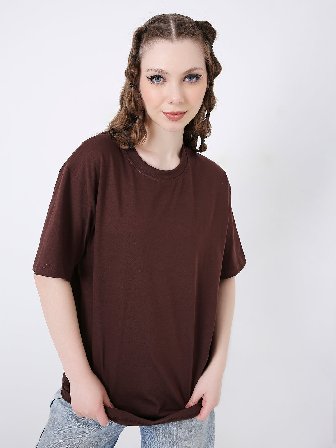 Relaxed fit solid brown short-sleeve t-shirt with crew neck, worn by a woman with light wash jeans.