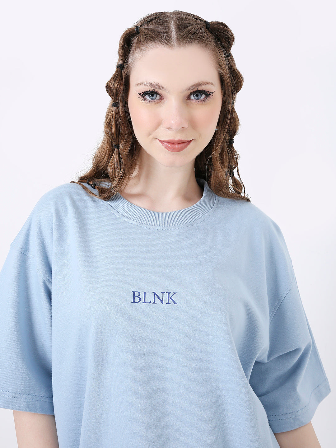 Light blue oversized T-shirt with navy "BLNK" text centered on chest, crew neck, short sleeves.
