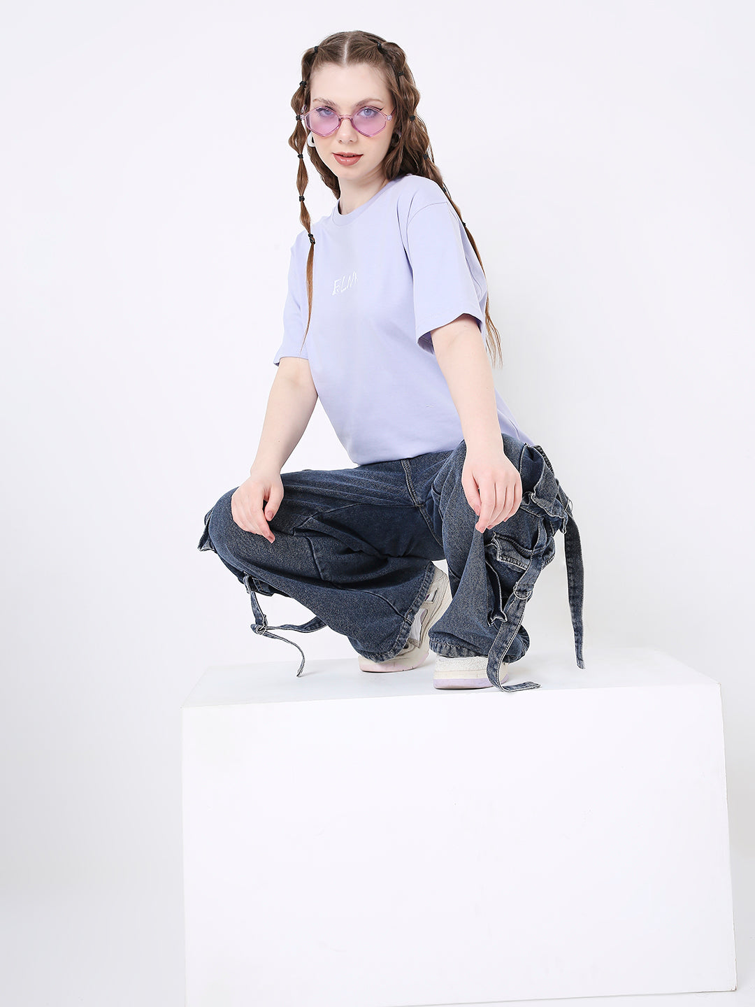 Lavender relaxed fit T-shirt with short sleeves, worn with dark ripped jeans and sunglasses.