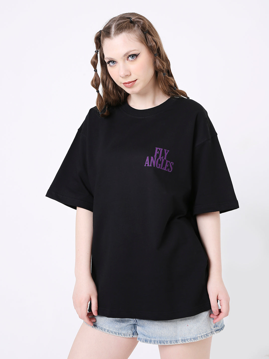 Oversize black T-shirt with purple "Fly Angels" print on front, worn with light denim shorts.