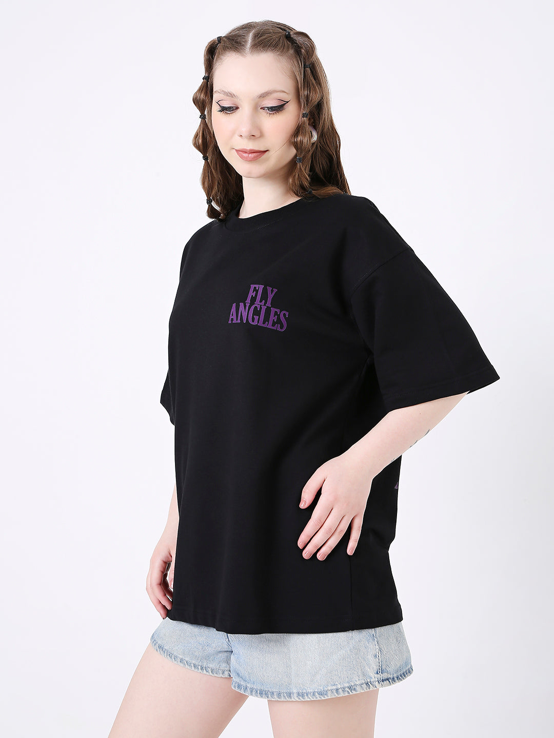 Oversize black T-shirt with purple "NY ANGLES" print, worn with light denim shorts.