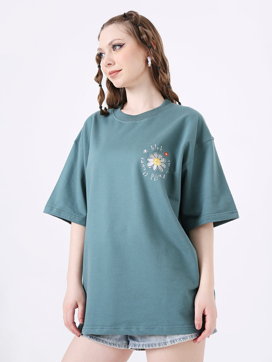 Oversize sapphire blue T-shirt with sun and moon graphic on chest, worn with denim shorts.
