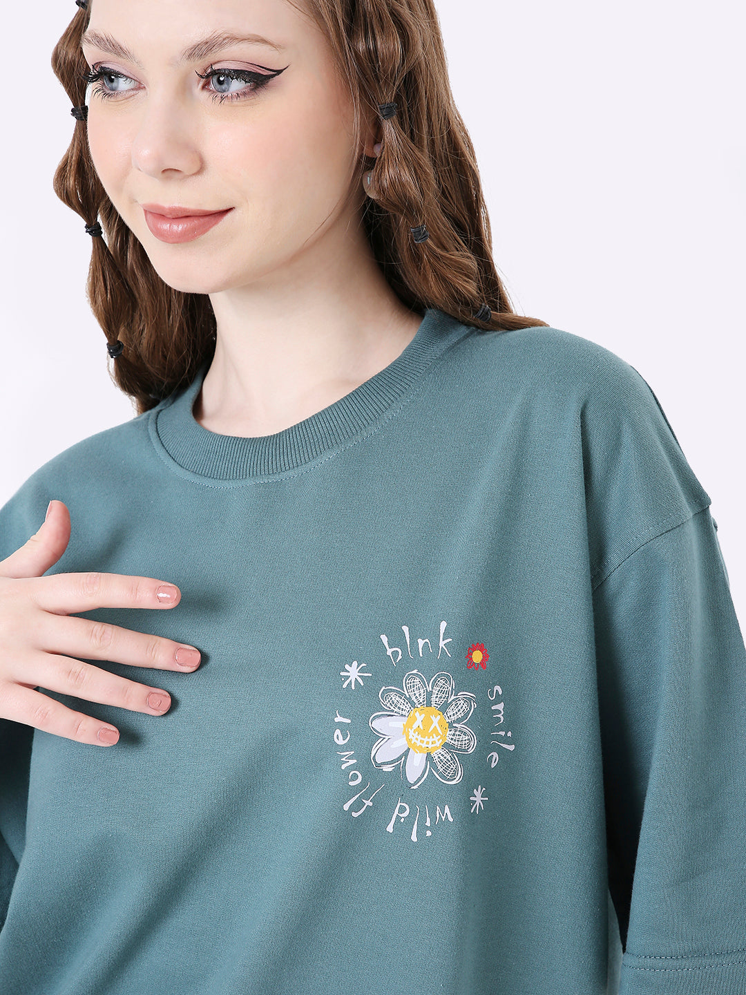 Oversize sapphire blue t-shirt with white daisy and inspirational text print on chest.