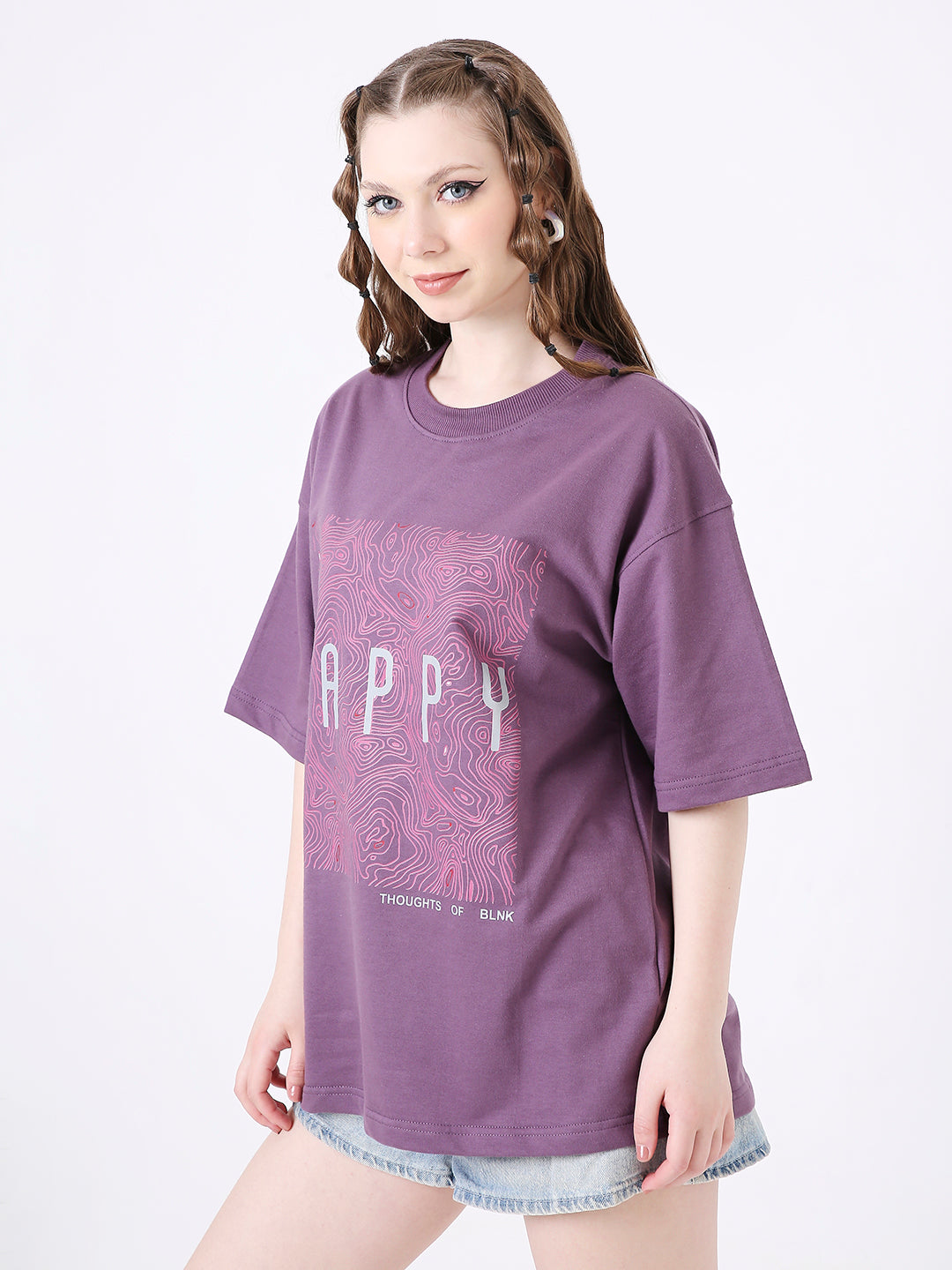 Oversized purple T-shirt with grape graphic and "HAPPY" text, worn with denim shorts.