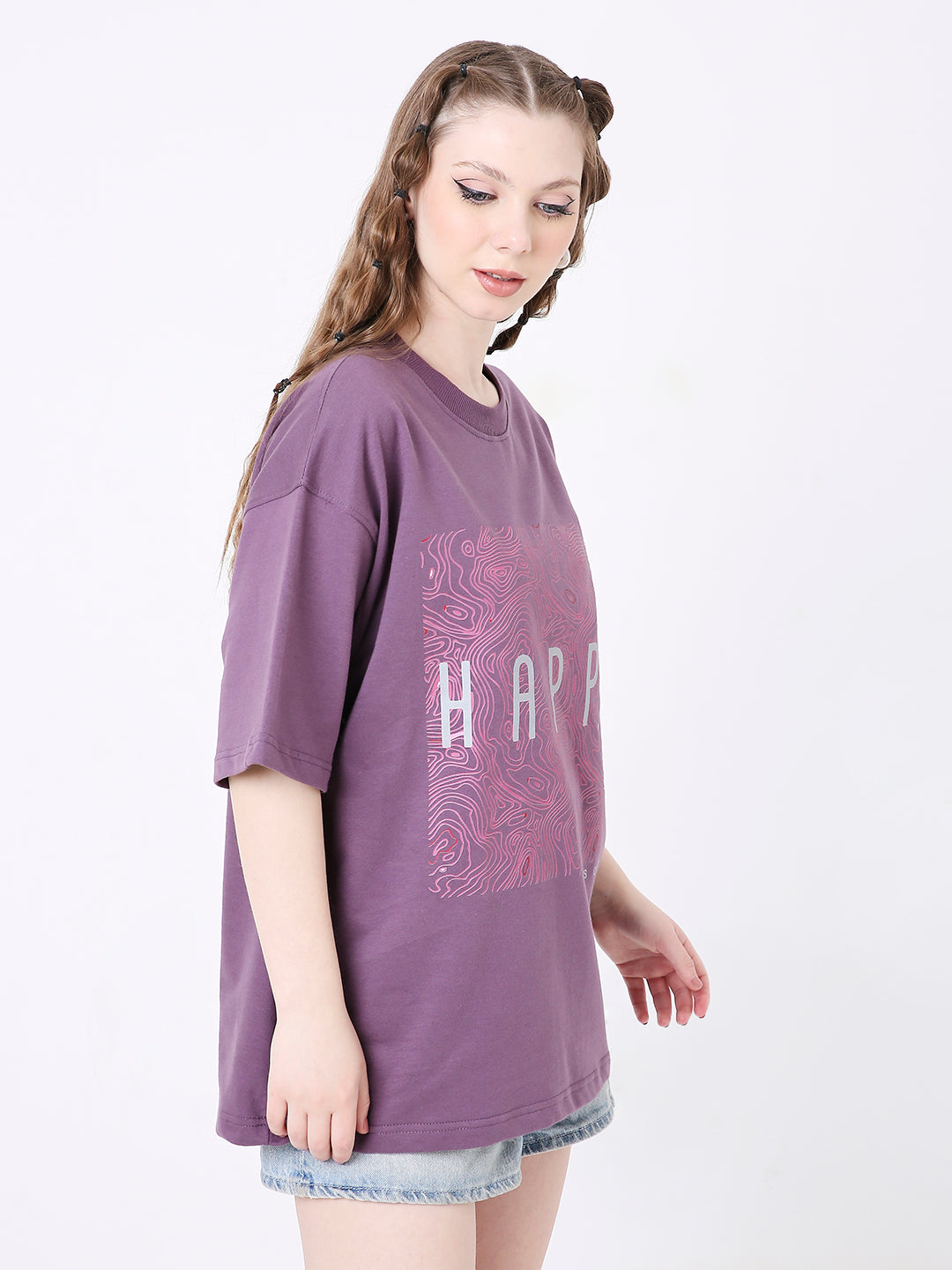 Oversize purple t-shirt with pink grape print and "HARD" text, worn with denim shorts.