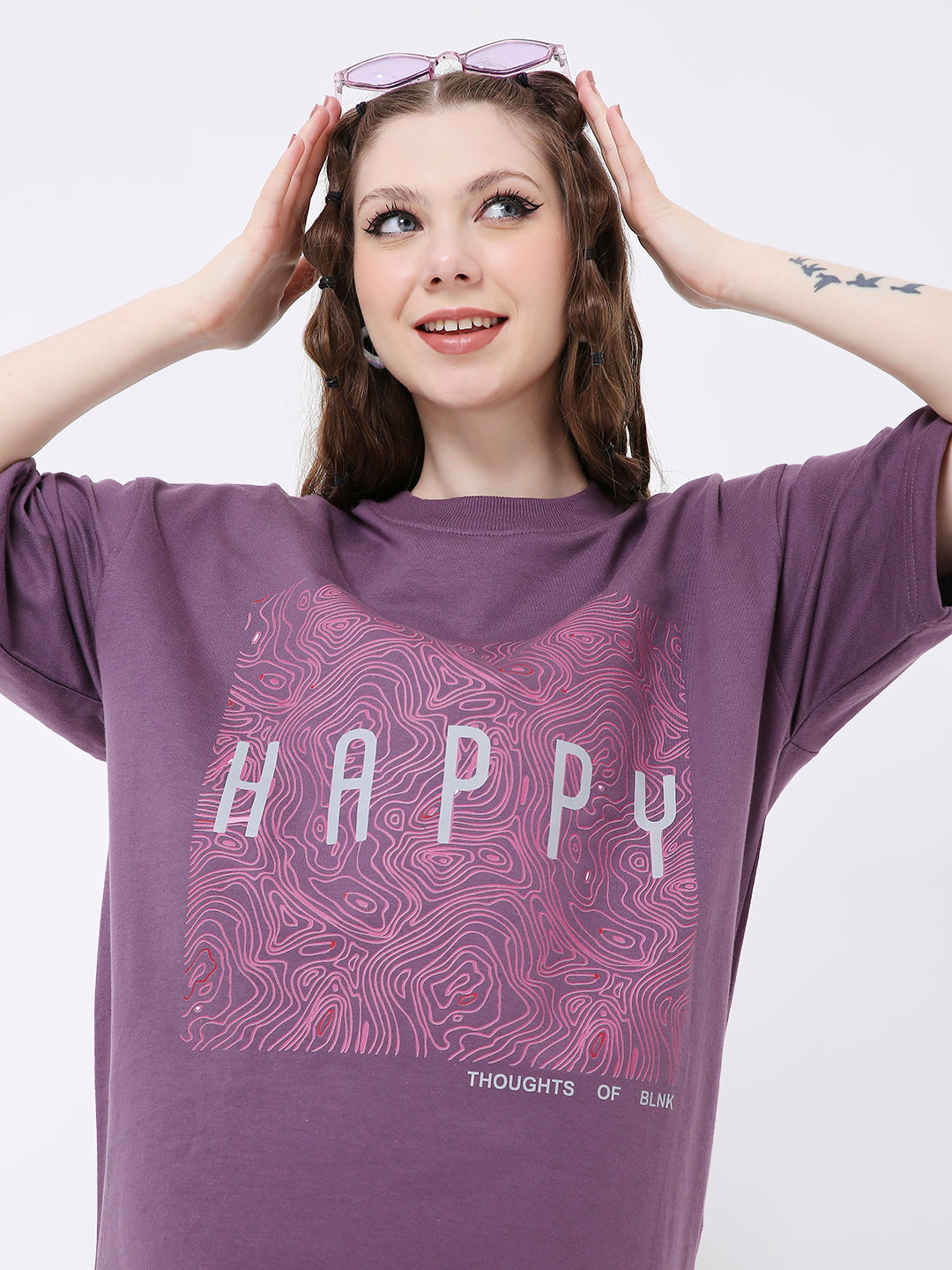 Oversized purple T-shirt with abstract grape print and "HAPPY" text on front.