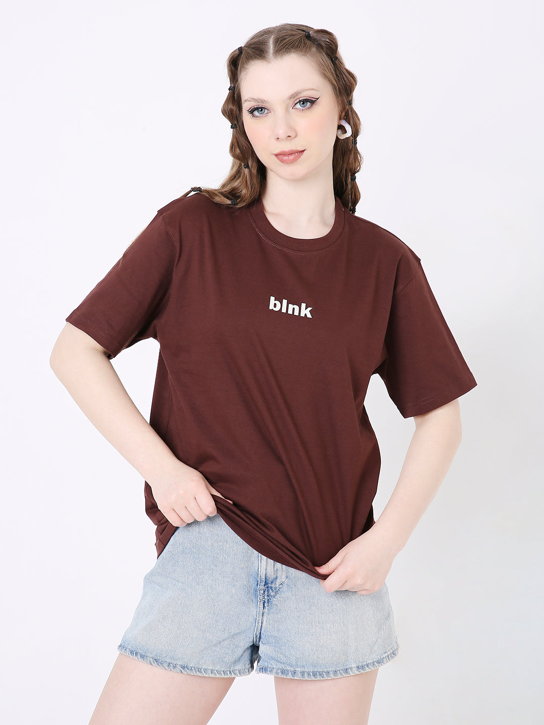 Brown relaxed fit T-shirt with small white "blink" text on chest, paired with light denim shorts.