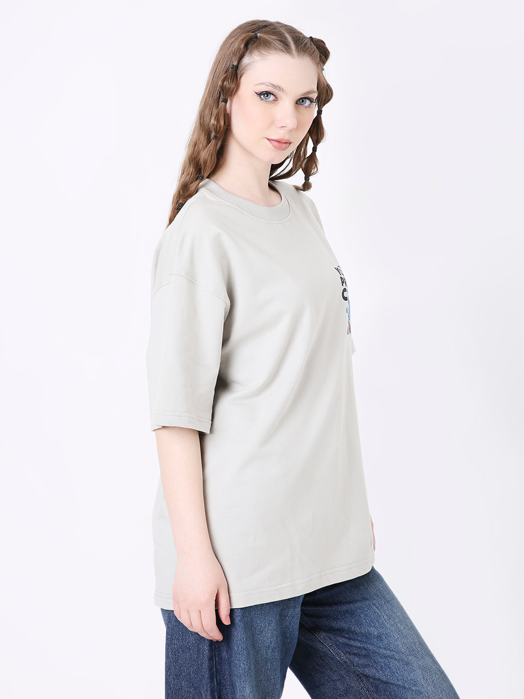 Light gray oversized T-shirt with black skipping stone graphic on chest, paired with blue jeans.