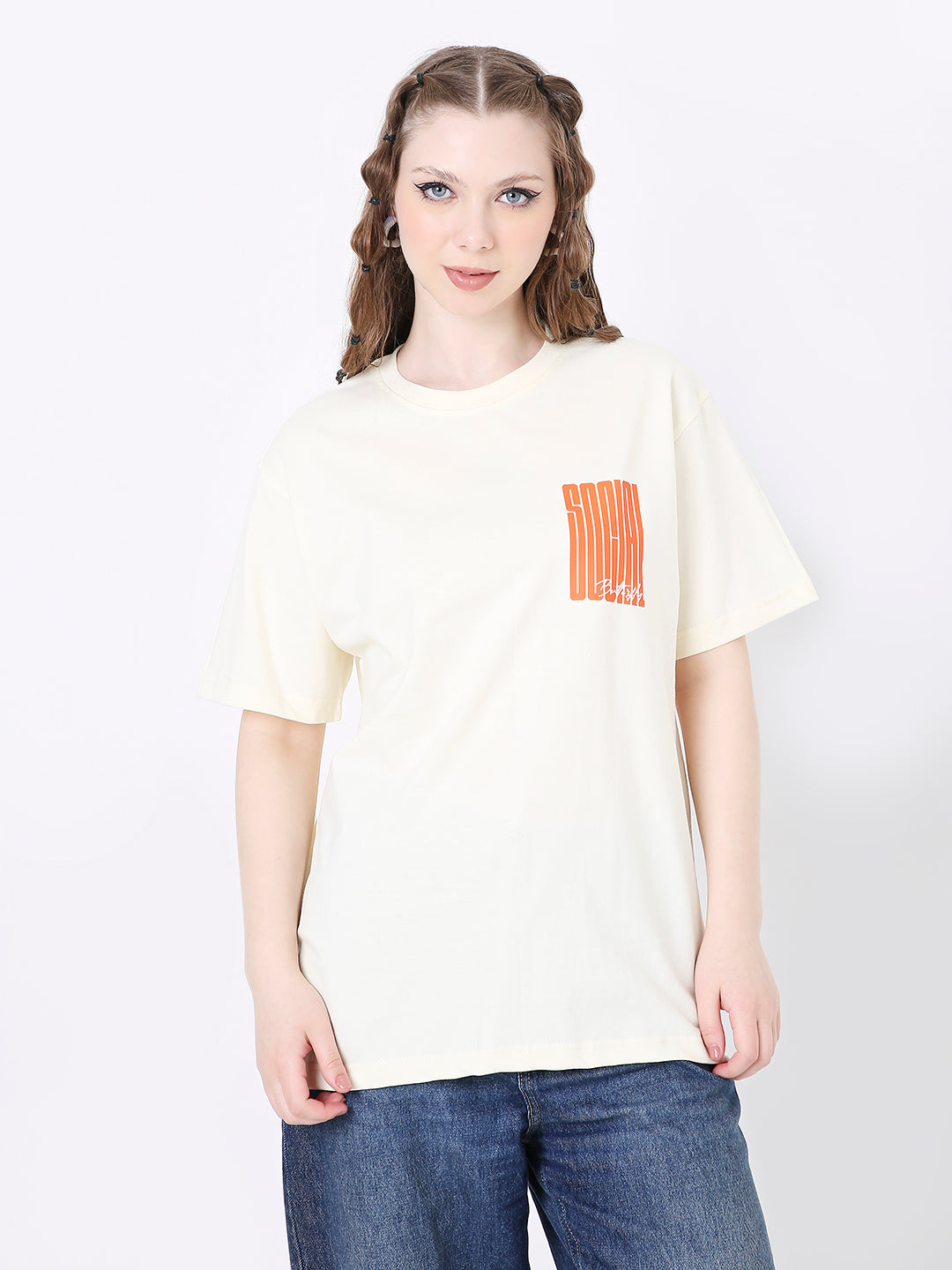 Off-white relaxed fit T-shirt with small orange printed graphic on left chest, worn with blue jeans.