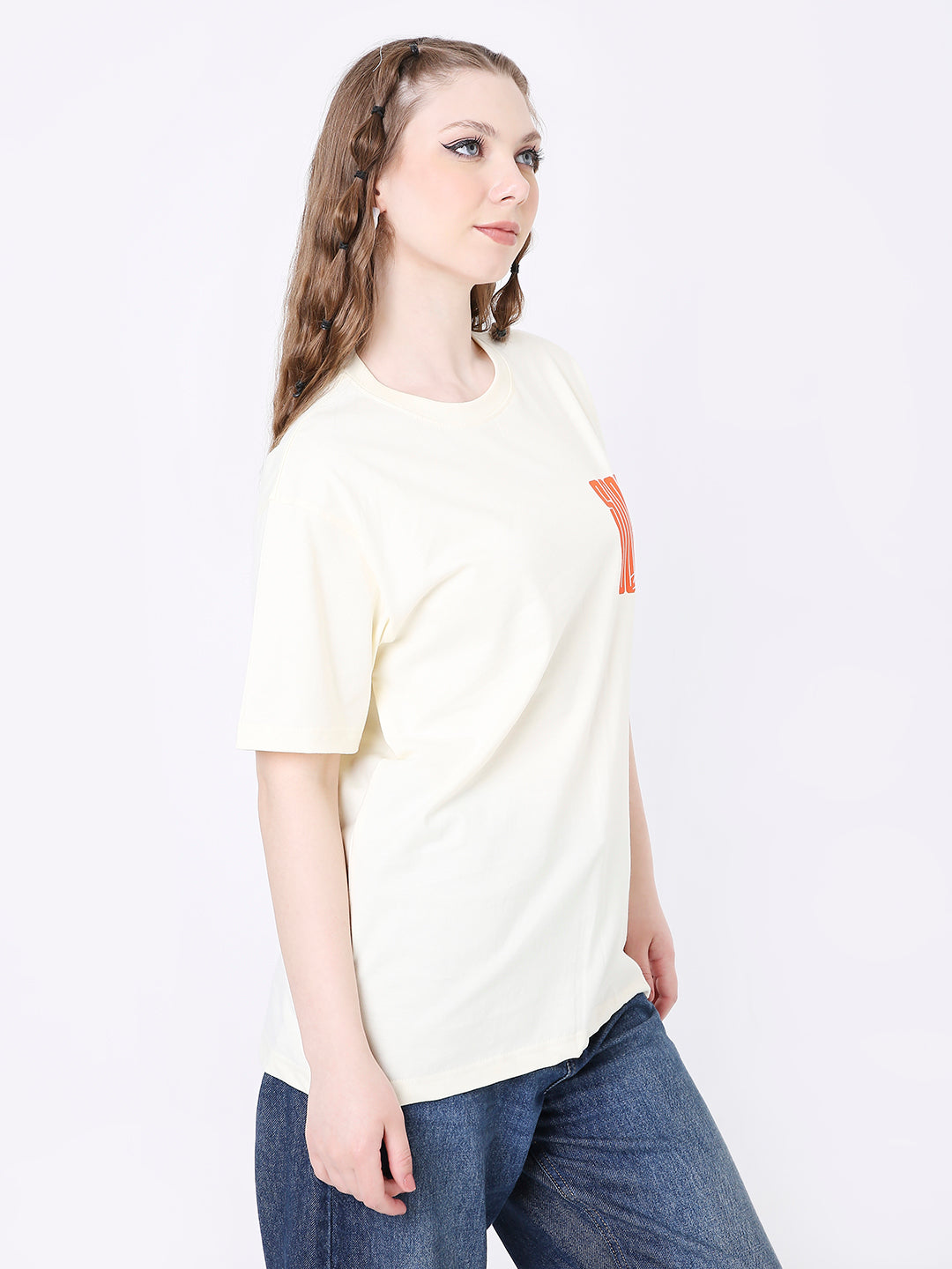 Off-white relaxed fit T-shirt with orange graphic on left chest, paired with blue jeans.