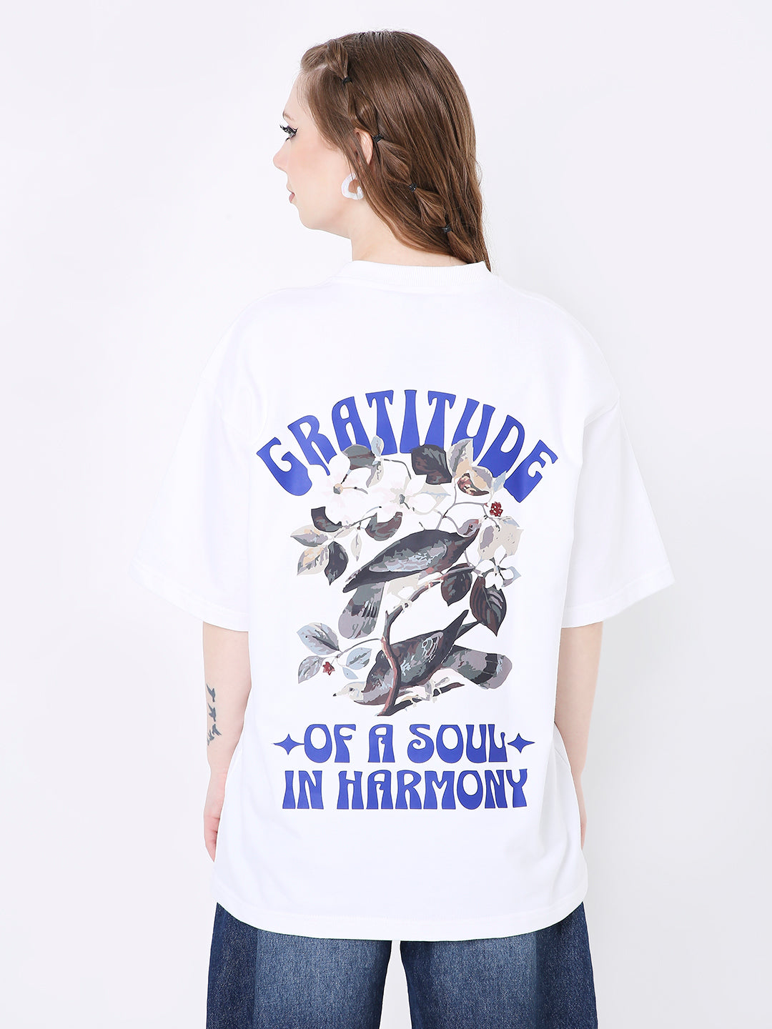 Oversize white t-shirt with blue "Gratitude of a Soul in Harmony" text and black leaf graphic on back.