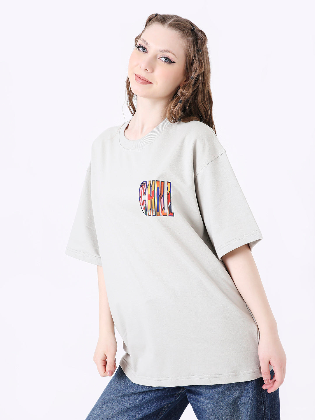 Oversized light gray t-shirt with colorful "CHILL" text printed on the chest pocket area.