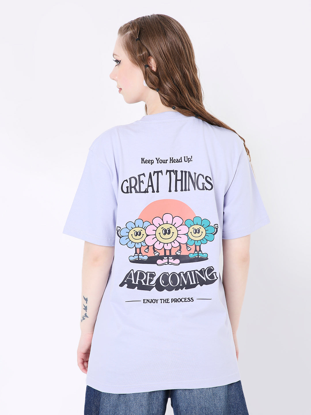 Lavender relaxed fit t-shirt with colorful smiling flower print and black text on back.