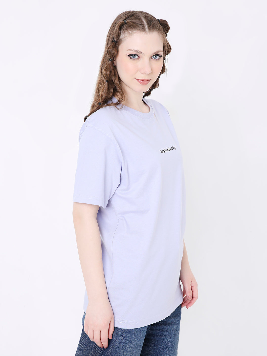 Lavender relaxed fit t-shirt with small black printed text on chest, worn with blue jeans.
