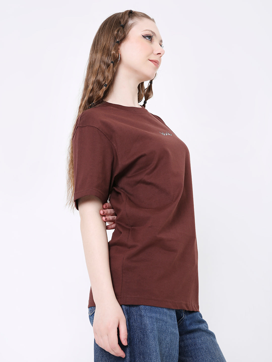 Brown relaxed fit t-shirt with short sleeves worn with blue jeans on a model.