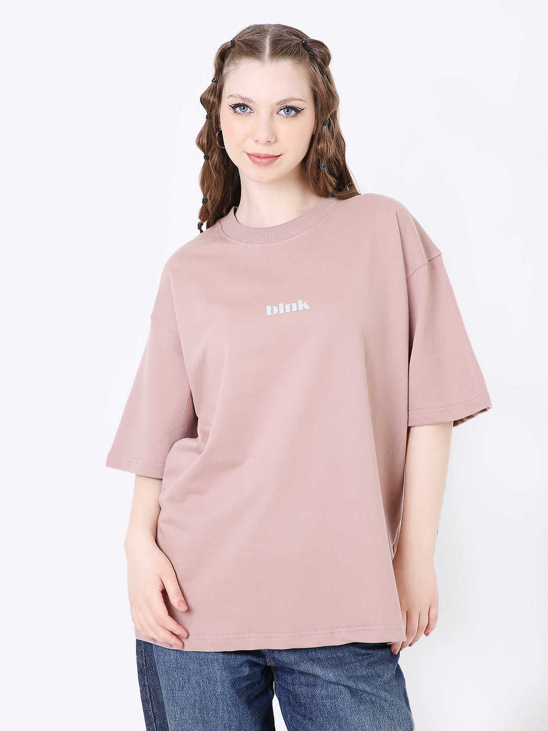 Oversized onion pink T-shirt with small white front text, worn with blue jeans.