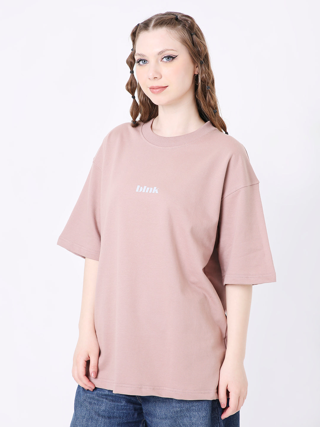 Oversize onion pink T-shirt with small white text on front, worn by model.