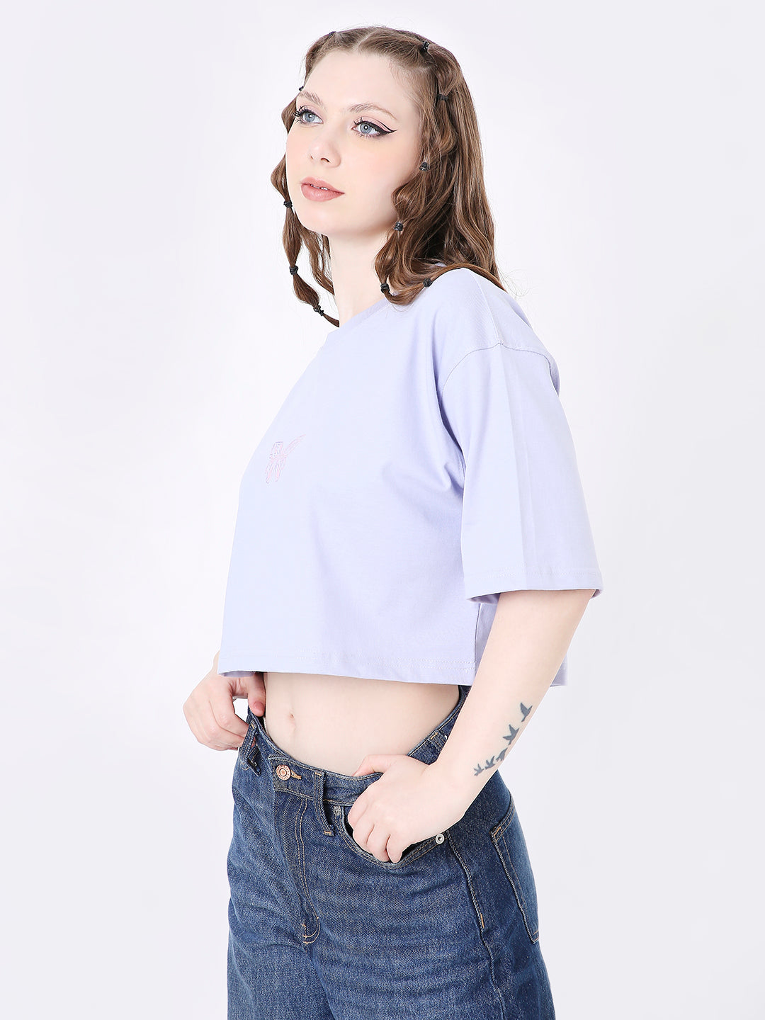 Lavender oversized crop top with short sleeves and relaxed fit on model wearing high-waisted jeans.