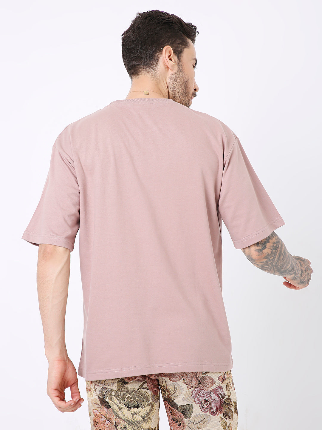 Oversize onion pink solid T-shirt with short sleeves, shown from back on male model.